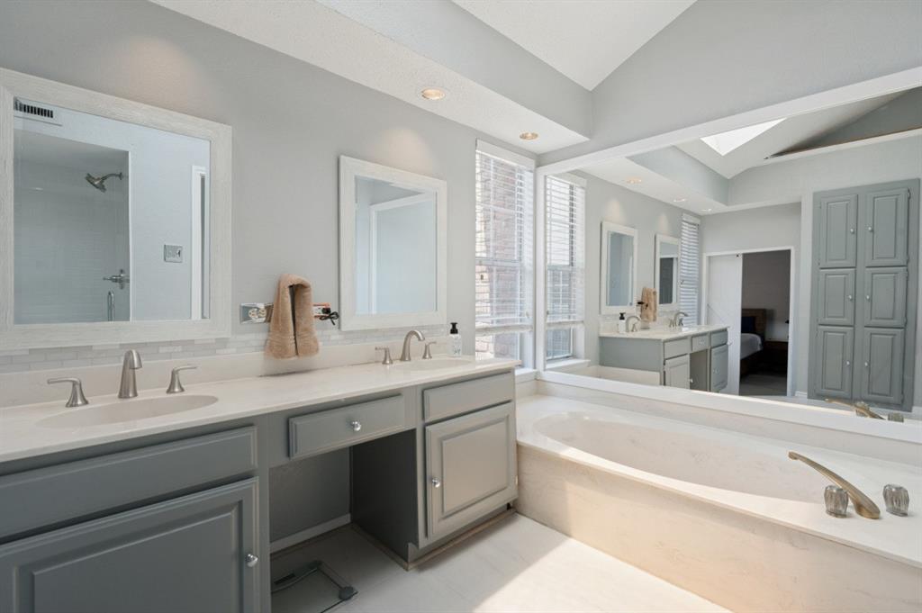 4050 Frankford Road, Unit 908 Dallas, TX 75287 - Photo 18 of 24 Spa-inspired primary bathroom featuring dual vanities with gray cabinetry, white quartz countertops, and polished nickel fixtures