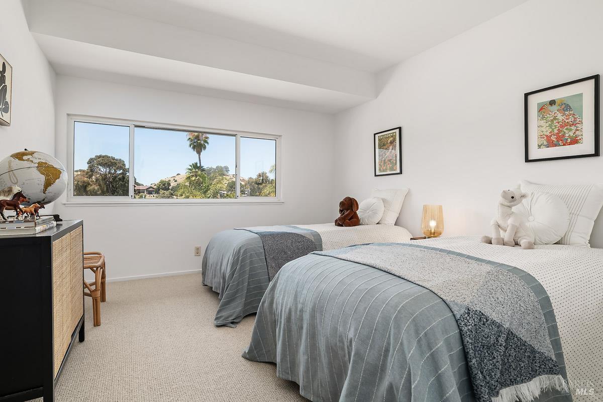 316 Riviera Drive San Rafael, CA 94901 - Photo 27 of 41 a bedroom with two beds and a large window