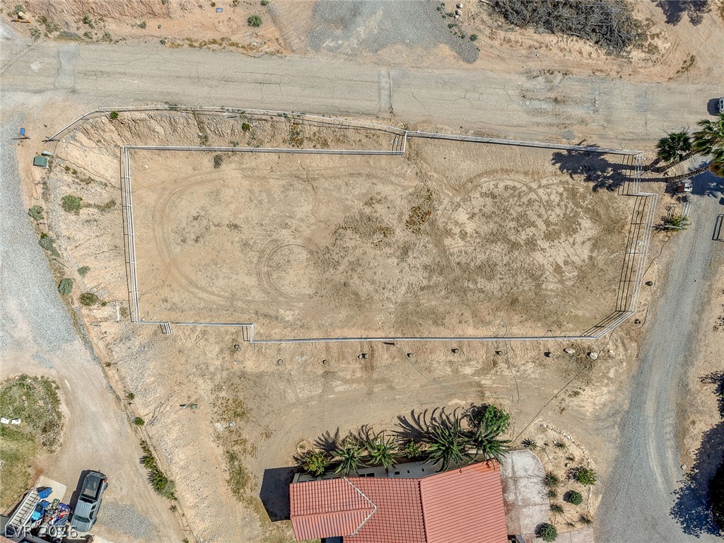 1950 Bowman Road Logandale, NV 89021 - Photo 74 of 81 An aerial perspective reveals a spacious lot with fenced-in arena, offering vast potential for outdoor endeavors.