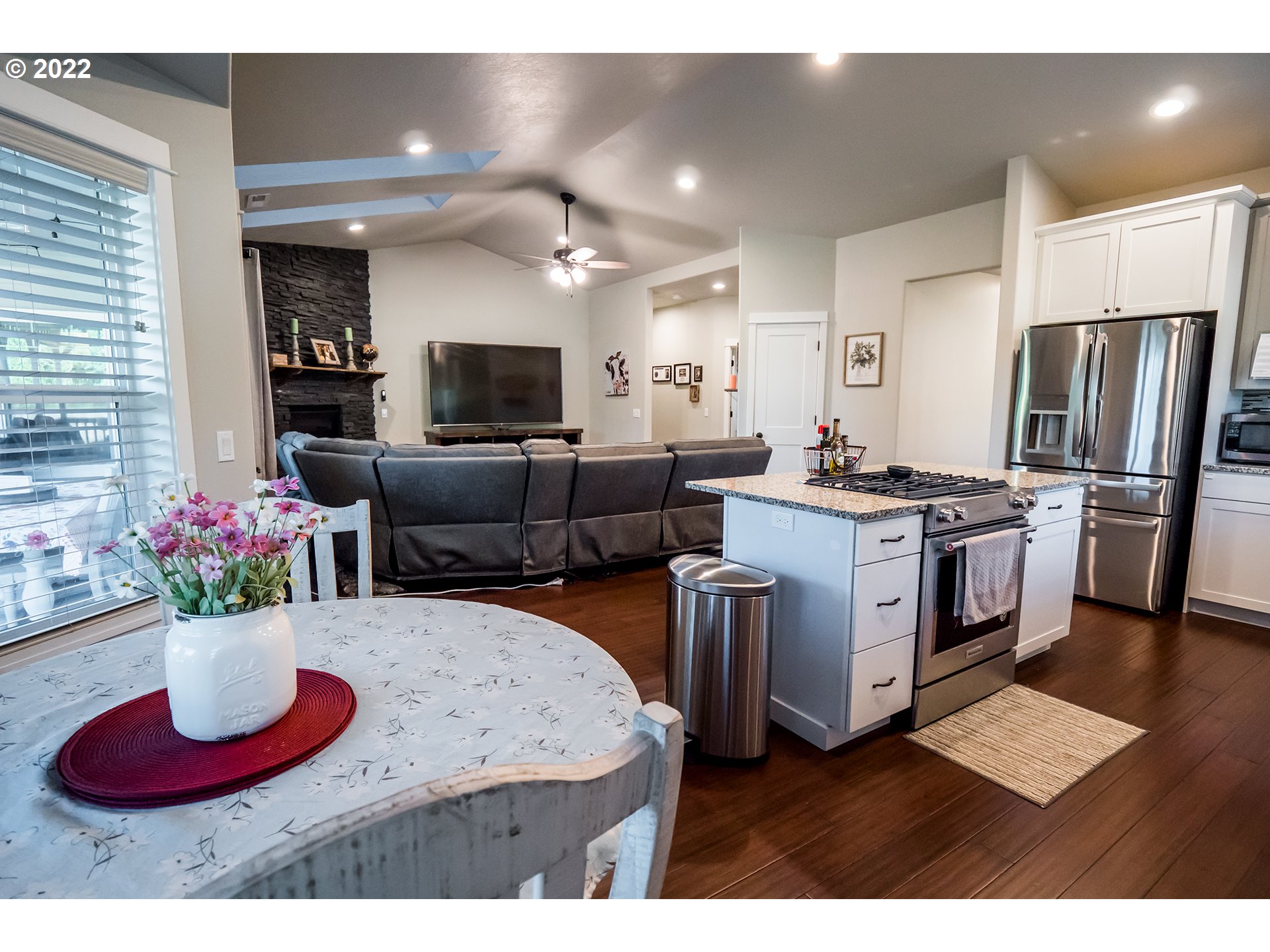 203 Ash Street Springfield, OR 97477 - Photo 3 of 32 a kitchen with stainless steel appliances kitchen island granite countertop a dining table and chairs