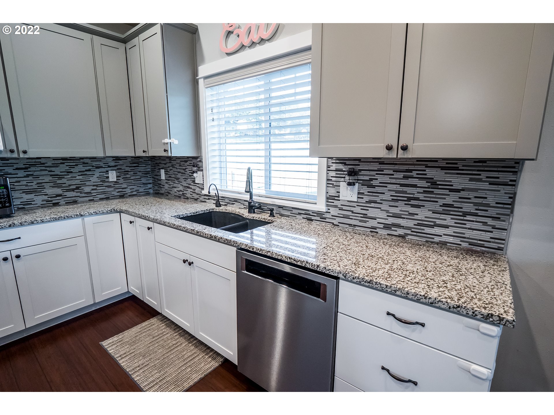 203 Ash Street Springfield, OR 97477 - Photo 4 of 32 a kitchen with granite countertop a sink and cabinets