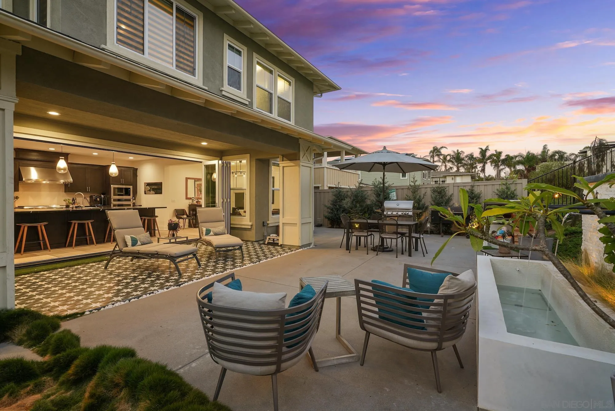 927 Moonstone Court Encinitas, CA 92024 - Photo 18 of 31 a view of a patio with couches dining table and chairs with garden view