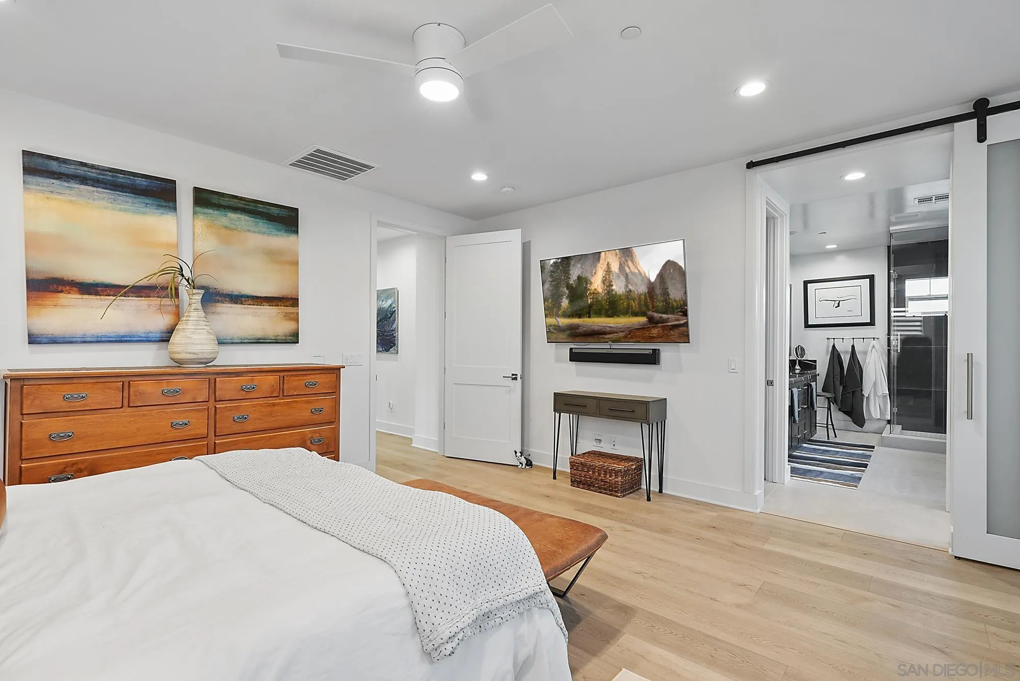927 Moonstone Court Encinitas, CA 92024 - Photo 20 of 31 a bedroom with a bed and a flat screen tv