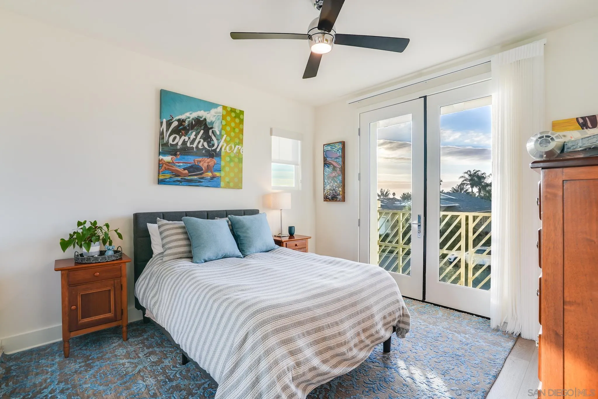 927 Moonstone Court Encinitas, CA 92024 - Photo 28 of 31 a bedroom with a bed and a painting on the wall