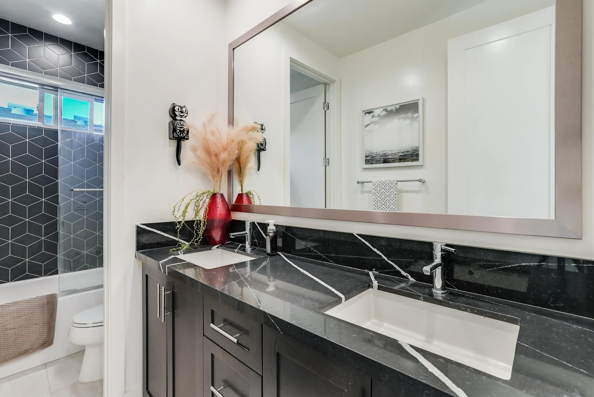 927 Moonstone Court Encinitas, CA 92024 - Photo 30 of 31 a bathroom with a sink and a mirror