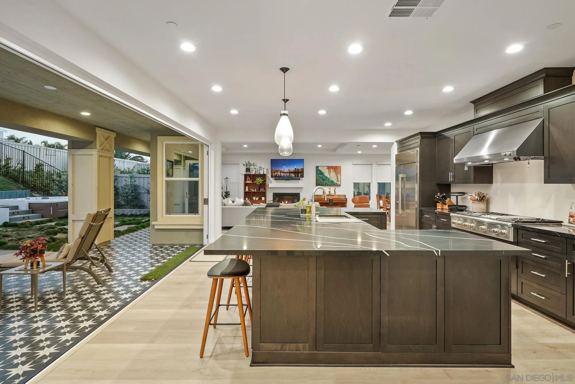 927 Moonstone Court Encinitas, CA 92024 - Photo 3 of 31 a kitchen with stainless steel appliances kitchen island granite countertop a sink and cabinets