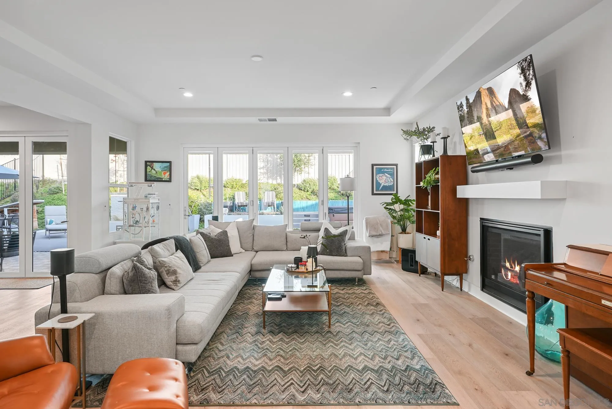927 Moonstone Court Encinitas, CA 92024 - Photo 7 of 31 a living room with furniture a fireplace and a flat screen tv