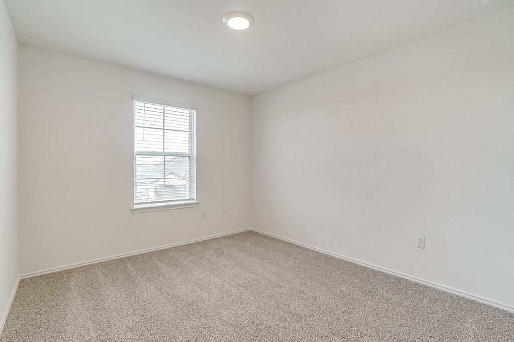 14824 Grey Ghost Way, Unit A Manor, TX 78653 - Photo 11 of 20 an empty room with a window