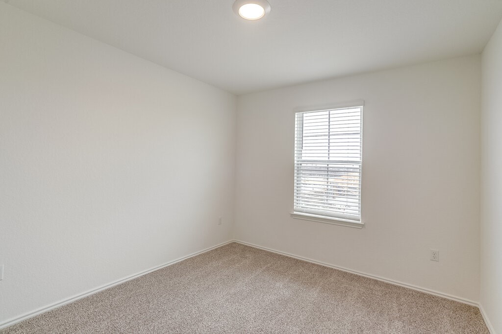 14824 Grey Ghost Way, Unit A Manor, TX 78653 - Photo 12 of 20 an empty room with a window
