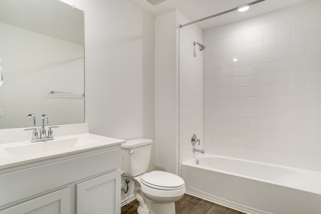 14824 Grey Ghost Way, Unit A Manor, TX 78653 - Photo 13 of 20 a bathroom with a sink a toilet and a mirror
