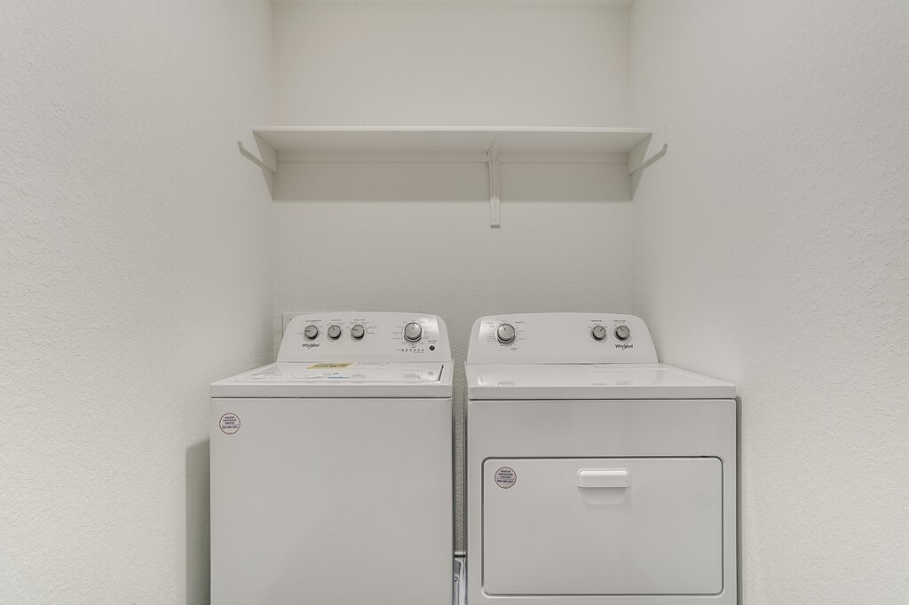 14824 Grey Ghost Way, Unit A Manor, TX 78653 - Photo 14 of 20 a close up of a utility room with dryer and washer