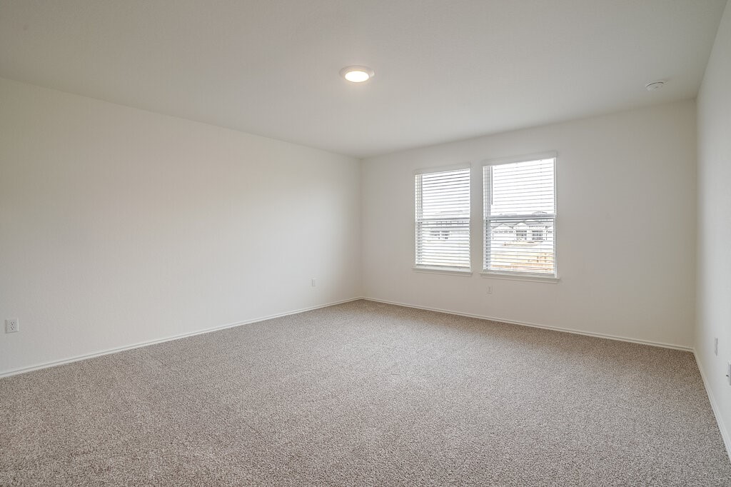 14824 Grey Ghost Way, Unit A Manor, TX 78653 - Photo 16 of 20 an empty room with windows