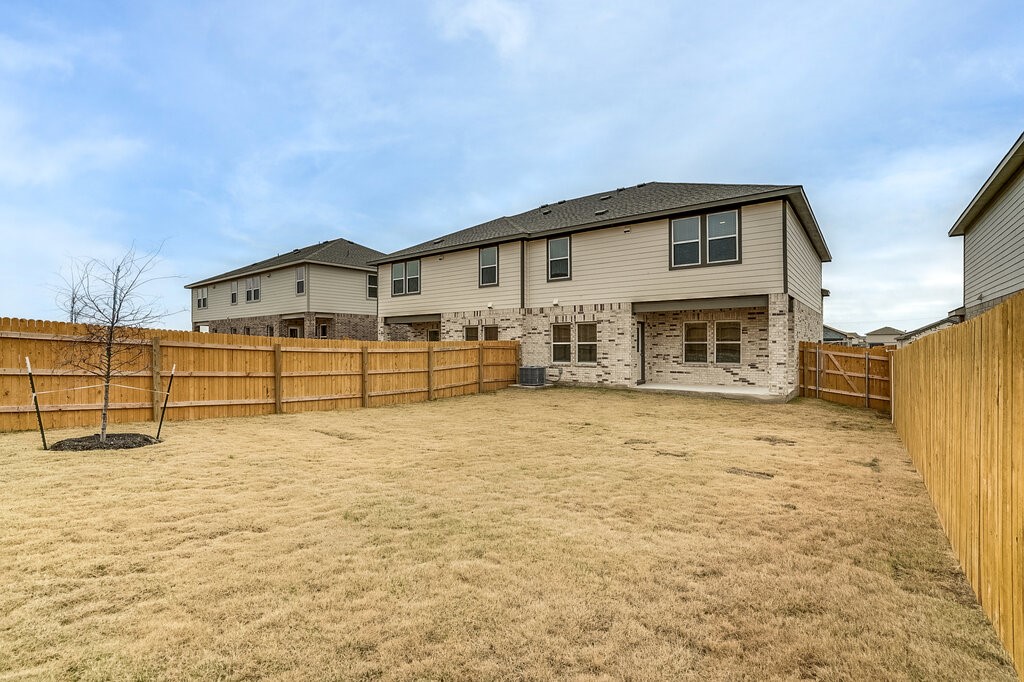 14824 Grey Ghost Way, Unit A Manor, TX 78653 - Photo 20 of 20 a view of a house with a yard