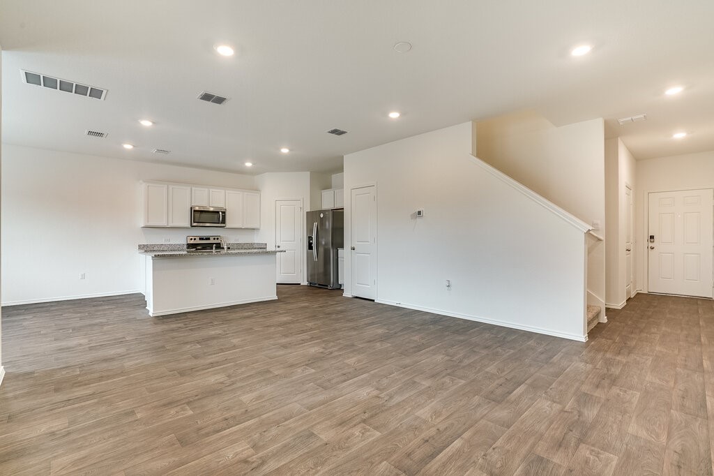 14824 Grey Ghost Way, Unit A Manor, TX 78653 - Photo 9 of 20 a view of kitchen with stove and white cabinets