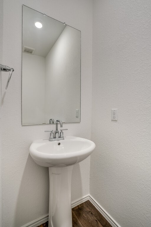 14824 Grey Ghost Way, Unit A Manor, TX 78653 - Photo 10 of 20 a bathroom with a sink a mirror and a toilet