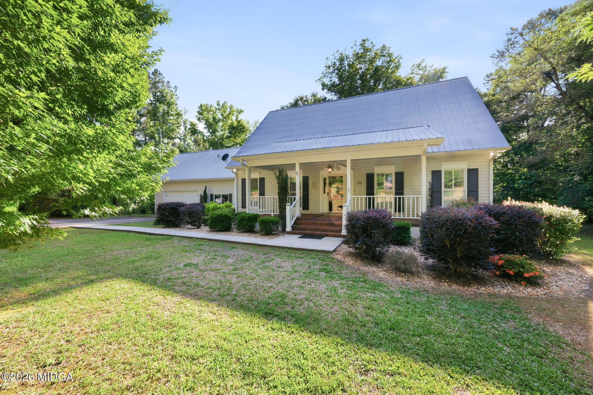 4686 Johnstonville Road Forsyth, GA 31029 - Photo 2 of 34 a view of a house with a yard and a garden