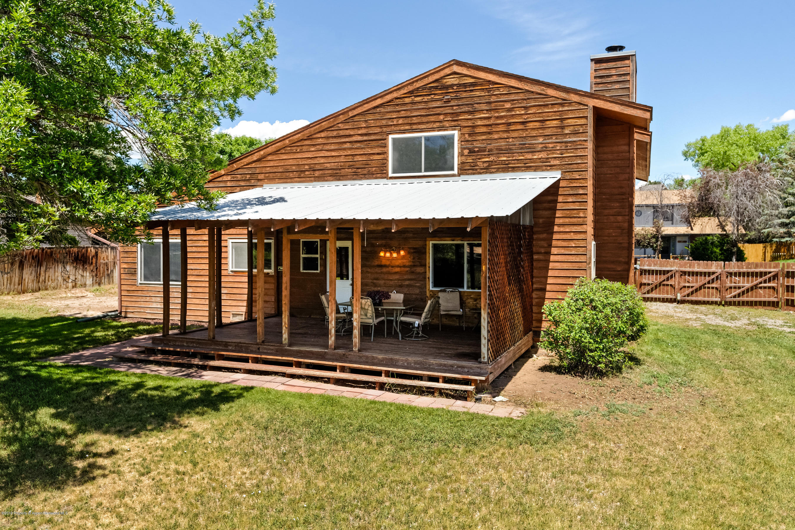 809 Cedar Drive Rifle, CO 81650 - Photo 4 of 22 a front view of a house with a yard