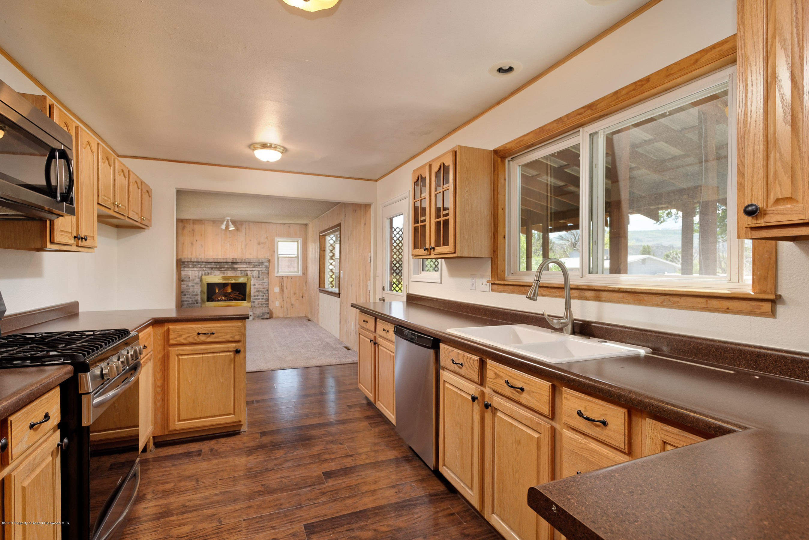 809 Cedar Drive Rifle, CO 81650 - Photo 6 of 22 a kitchen with granite countertop stainless steel appliances a stove sink and cabinets