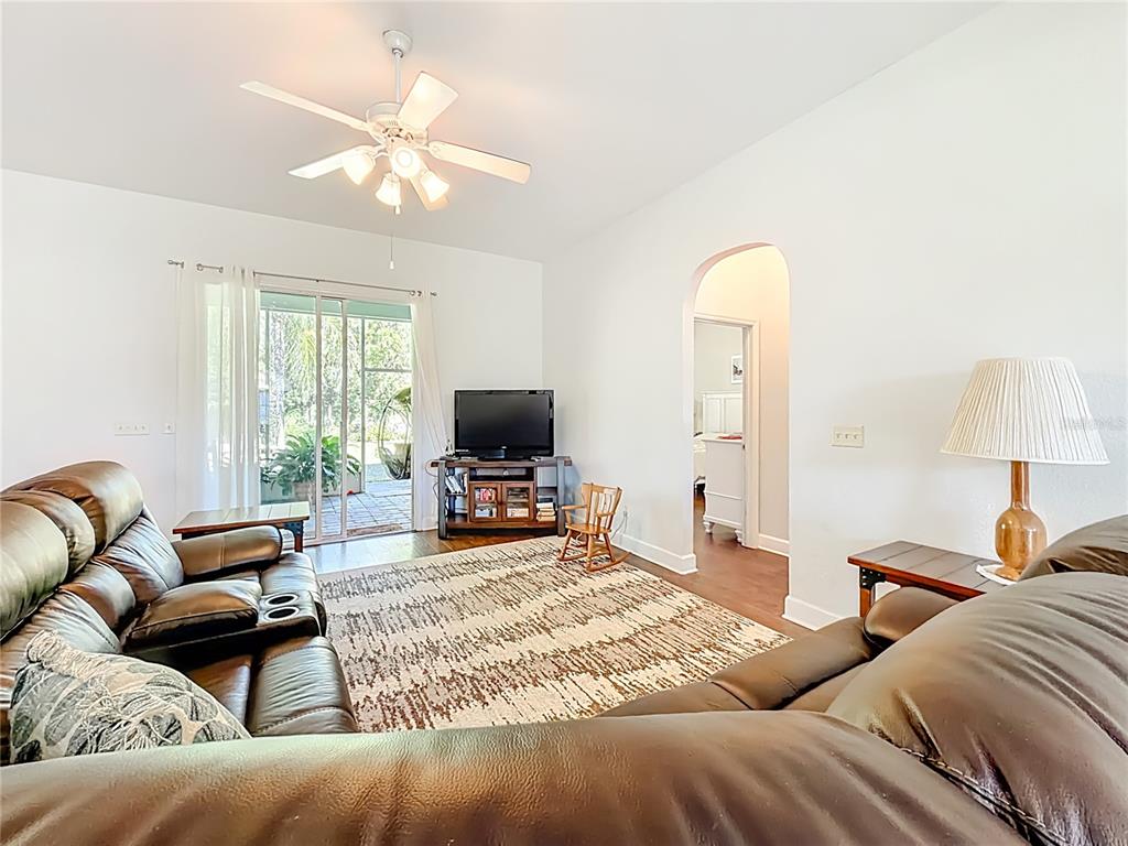 2301 Southeast 22nd Loop Ocala, FL 34471 - Photo 14 of 55 a living room with furniture a flat screen tv and a large window