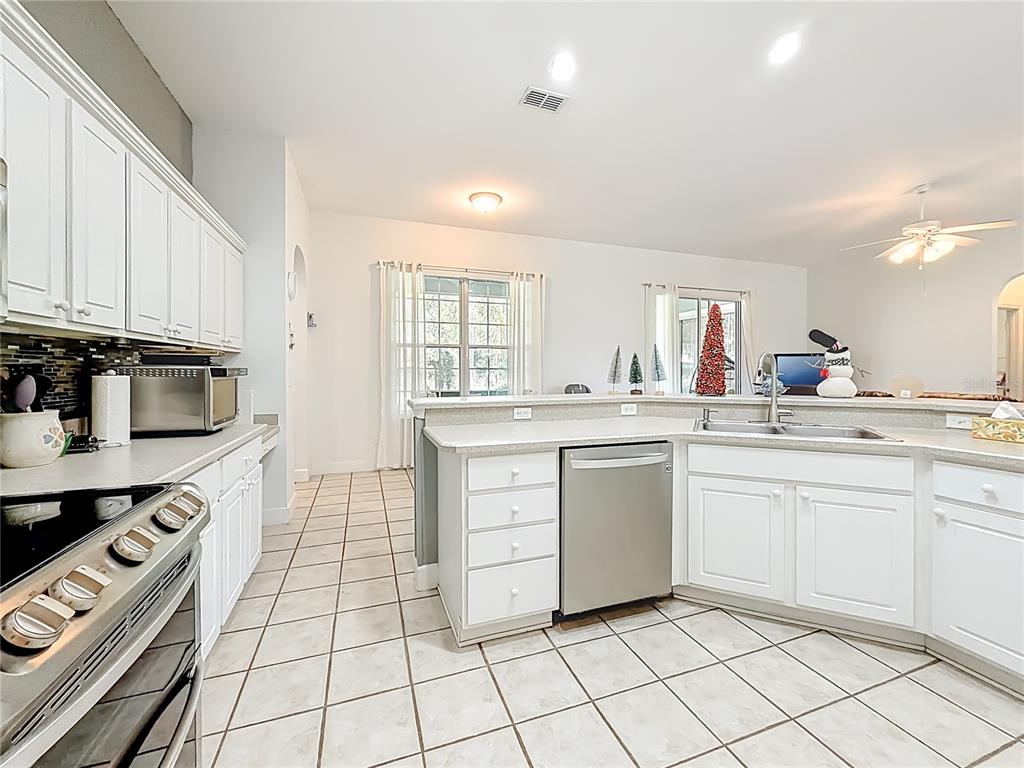 2301 Southeast 22nd Loop Ocala, FL 34471 - Photo 17 of 55 a kitchen with white cabinets appliances and a sink