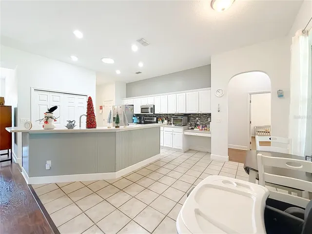 a kitchen with stainless steel appliances kitchen island granite countertop a sink and cabinets