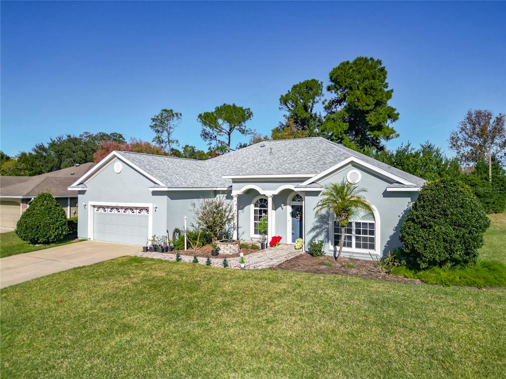 2301 Southeast 22nd Loop Ocala, FL 34471 - Photo 2 of 55 front view of a house with a small yard