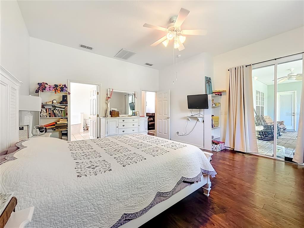 2301 Southeast 22nd Loop Ocala, FL 34471 - Photo 22 of 55 a spacious bedroom with a bed and a flat screen tv