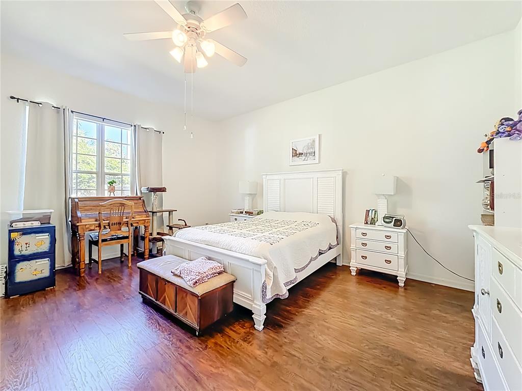 2301 Southeast 22nd Loop Ocala, FL 34471 - Photo 23 of 55 a spacious bedroom with a bed and wooden floor