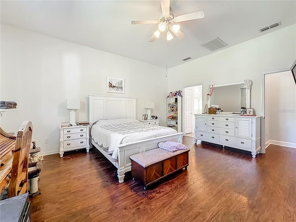 2301 Southeast 22nd Loop Ocala, FL 34471 - Photo 24 of 55 a spacious bedroom with a bed and a tv