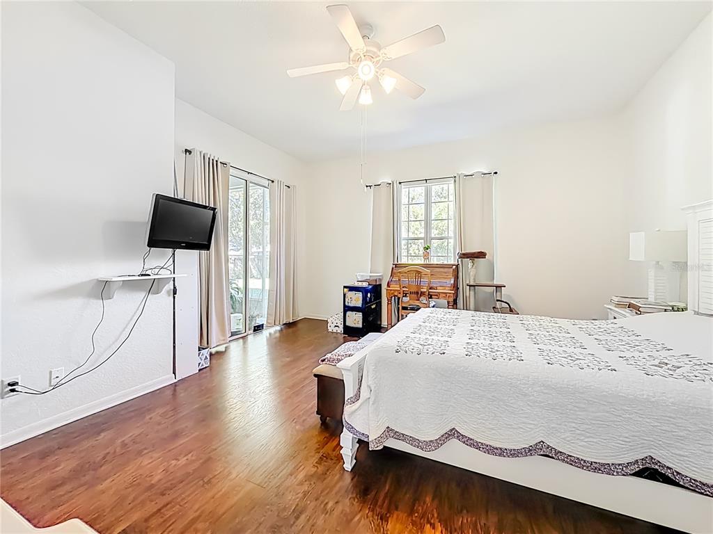 2301 Southeast 22nd Loop Ocala, FL 34471 - Photo 25 of 55 a bedroom with a bed and a flat tv screen on dresser