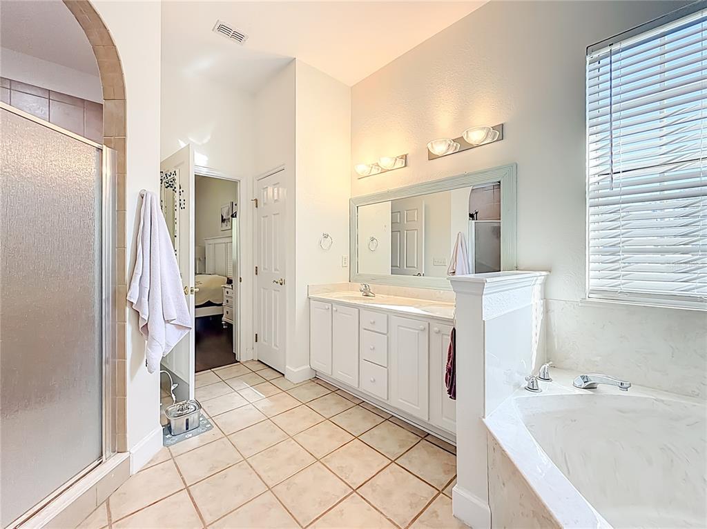 2301 Southeast 22nd Loop Ocala, FL 34471 - Photo 26 of 55 a bathroom with a tub sink and a mirror