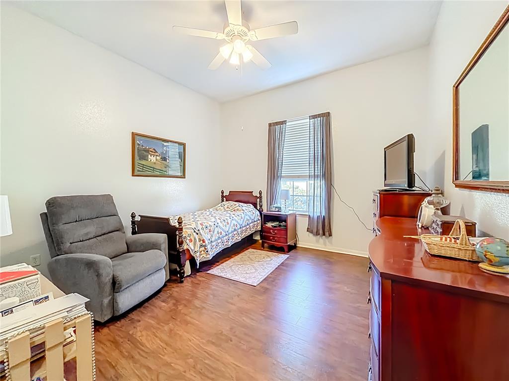 2301 Southeast 22nd Loop Ocala, FL 34471 - Photo 28 of 55 a bedroom with furniture and a wooden floor