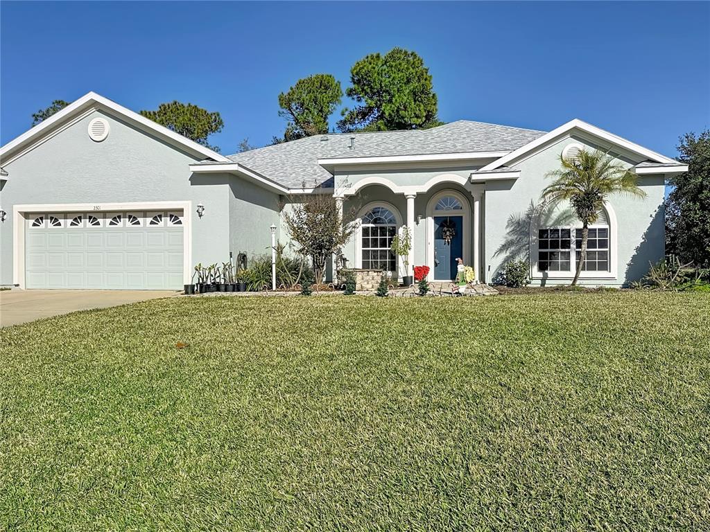 2301 Southeast 22nd Loop Ocala, FL 34471 - Photo 3 of 55 a view of a white house with a big yard and potted plants
