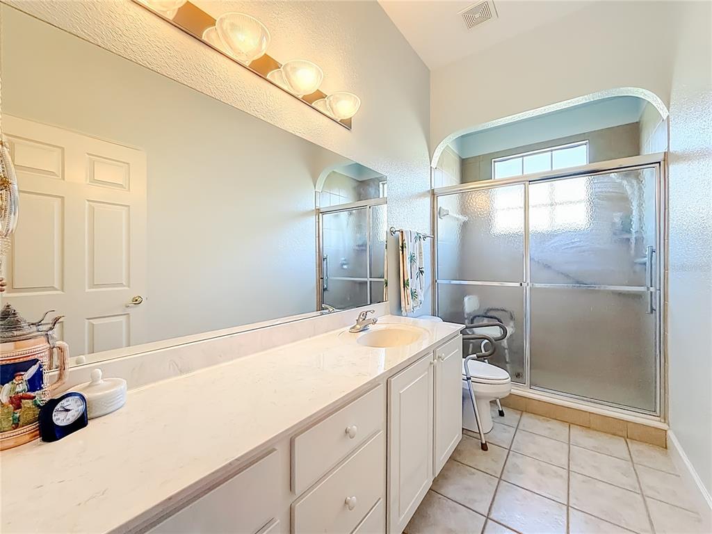 2301 Southeast 22nd Loop Ocala, FL 34471 - Photo 31 of 55 a bathroom with a sink a toilet and a shower