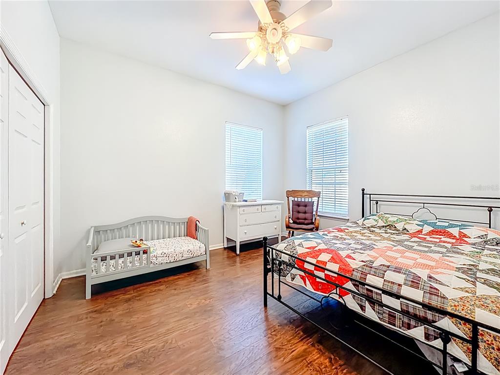 2301 Southeast 22nd Loop Ocala, FL 34471 - Photo 33 of 55 a bedroom with a bed and a chandelier