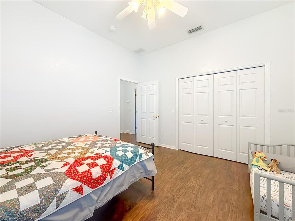 2301 Southeast 22nd Loop Ocala, FL 34471 - Photo 35 of 55 a bedroom with a bed and a chandelier