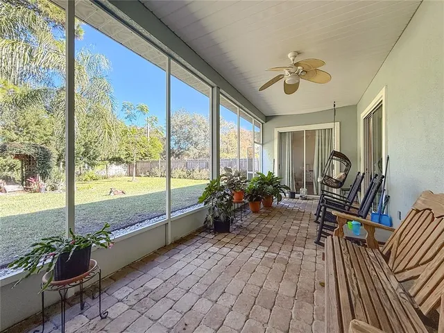 a view of a porch with furniture and garden