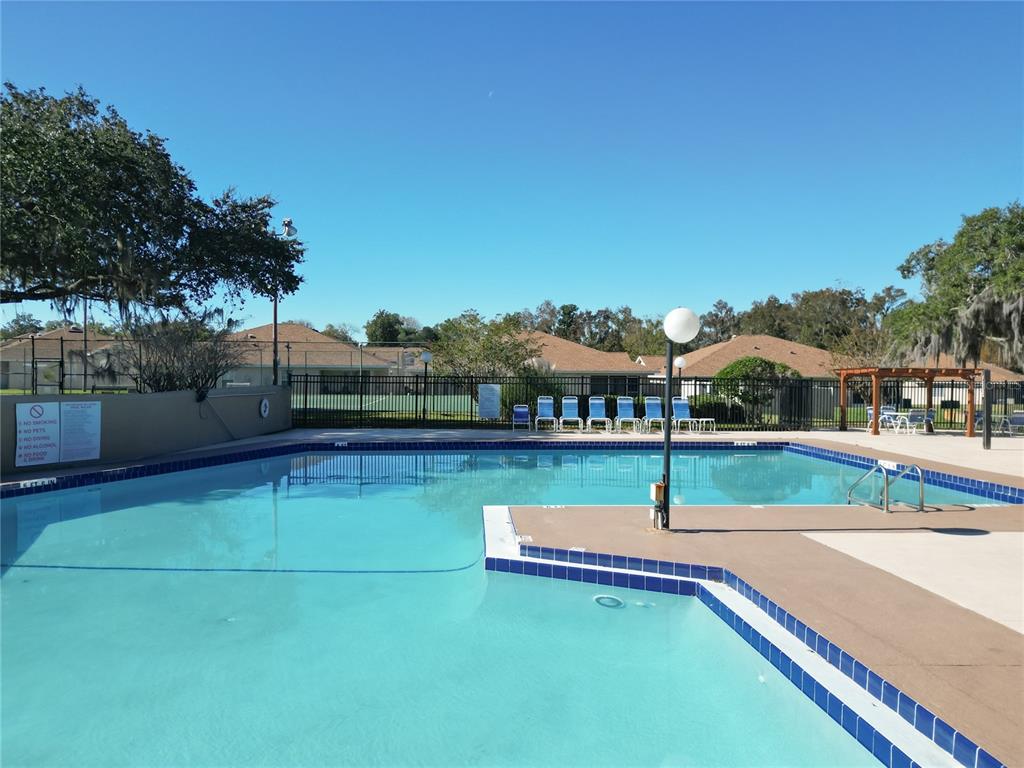 2301 Southeast 22nd Loop Ocala, FL 34471 - Photo 51 of 55 a swimming pool with outdoor seating and yard