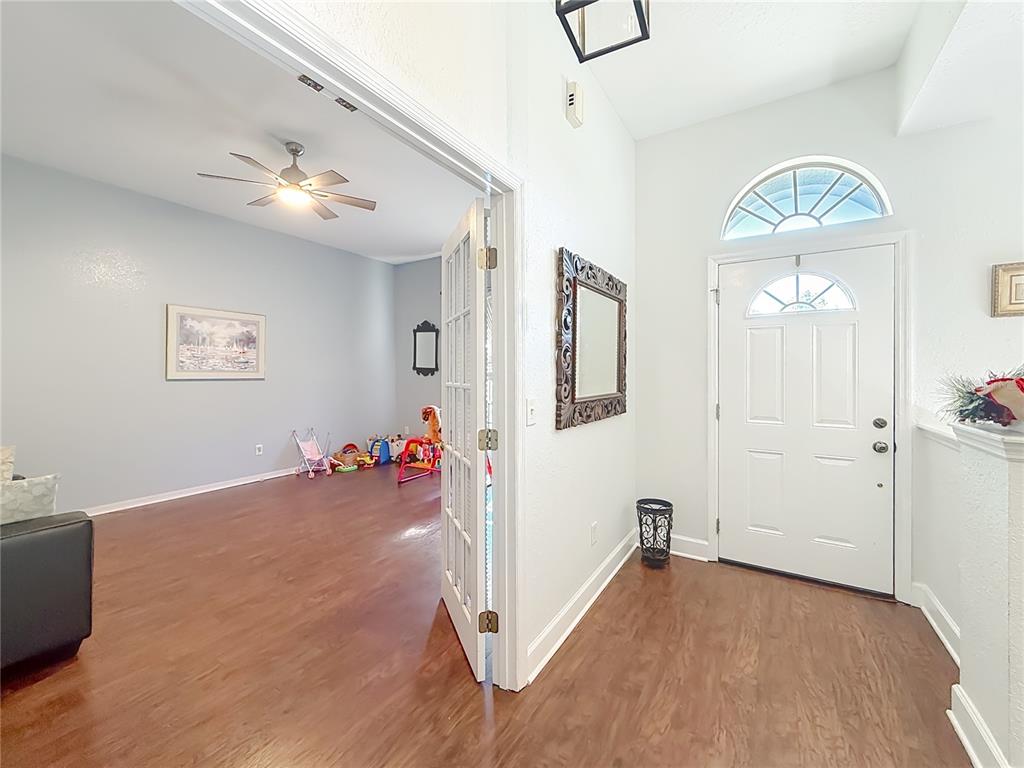 2301 Southeast 22nd Loop Ocala, FL 34471 - Photo 7 of 55 a view of a livingroom with wooden floor and an empty room