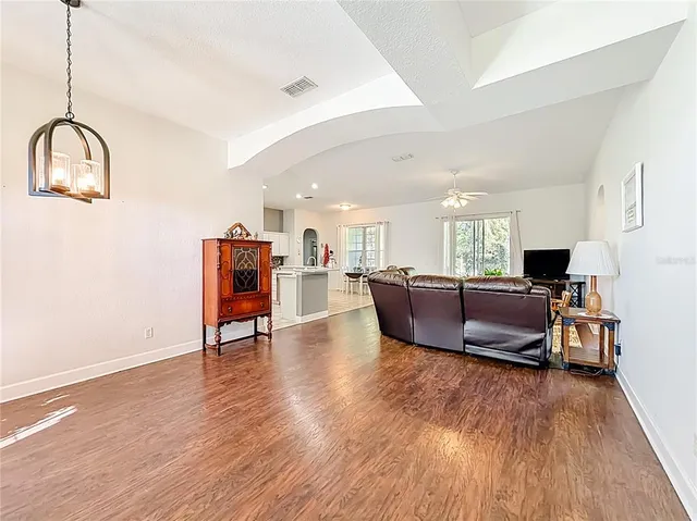 a living room with furniture and a chandelier