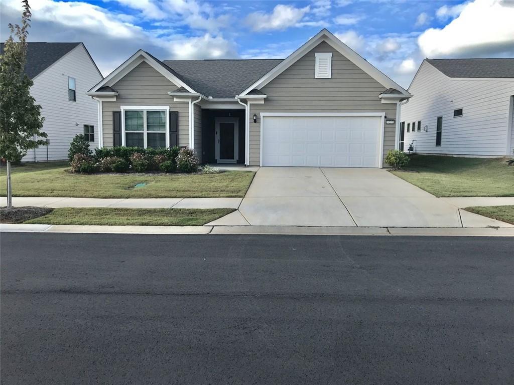5222 Morrell Road Hoschton, GA 30548 - Photo 1 of 45 a front view of a house with a yard and garage