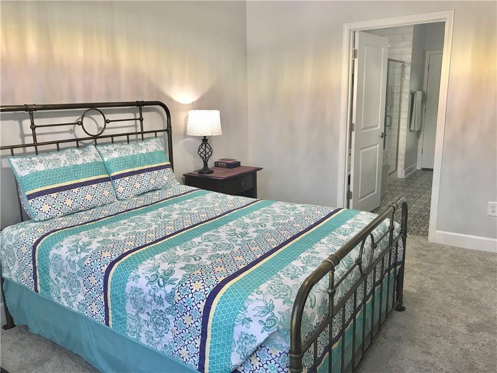 5222 Morrell Road Hoschton, GA 30548 - Photo 13 of 45 a bedroom with a bed and a lamp