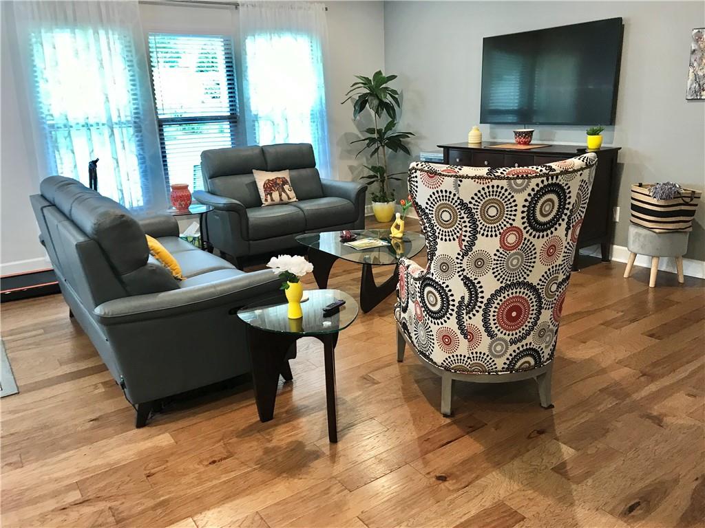 5222 Morrell Road Hoschton, GA 30548 - Photo 9 of 45 a living room with furniture and a flat screen tv
