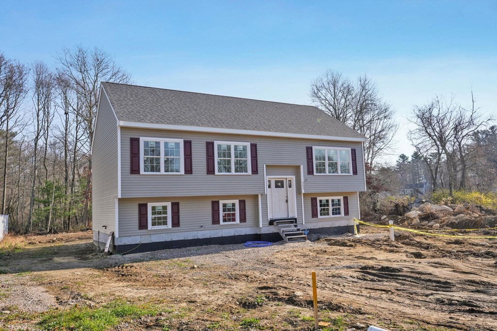 983 Stonegate Landing Dighton, MA 02764 - Photo 1 of 15 a front view of a house with a yard and garage
