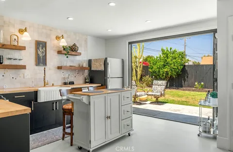 a kitchen with cabinets a stove and a chair