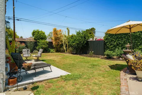 a swimming pool with outdoor seating and yard