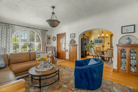 a living room with furniture a fireplace and a large window