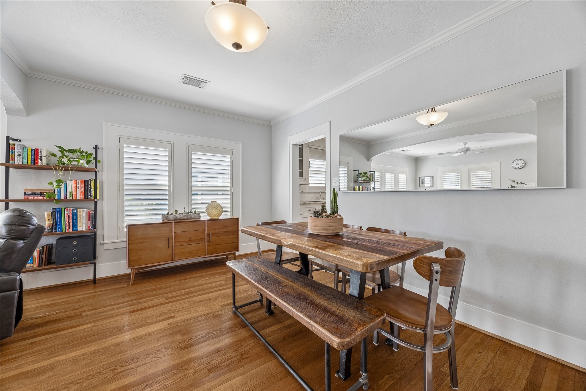 919 Key Street Houston, TX 77009 - Photo 8 of 39 A beautifully connected dining space featuring warm wood tones and an open pass-through—creating an effortless flow between gathering and everyday living.