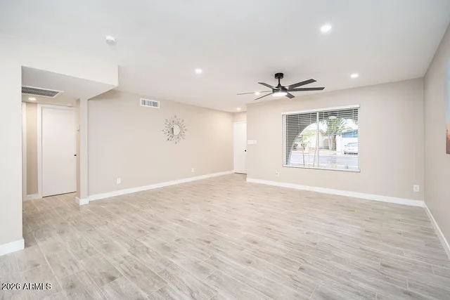 wooden floor in an empty room with a window