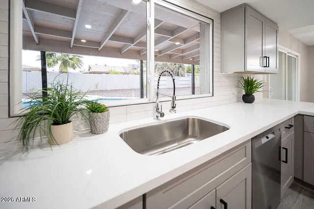 a kitchen with a sink and a large window